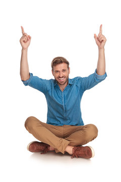 Happy Young Man With Hands In The Air Celebrating Success