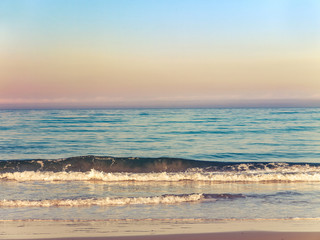 gentle waves splashing in the morning on the sand beach