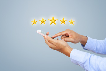 Hand of client giving a five star rating on smart phone. Service rating, satisfaction, customer experience concept