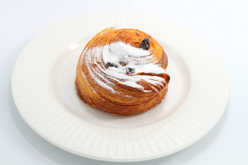 Freshly baked bun sprinkled with powdered sugar