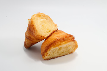 Freshly baked traditional croissant cut into two parts