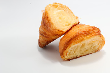 Freshly baked traditional croissant cut into two parts