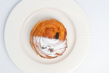 Freshly baked bun sprinkled with powdered sugar