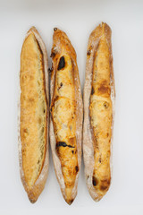 Three fresh French baguettes on white background