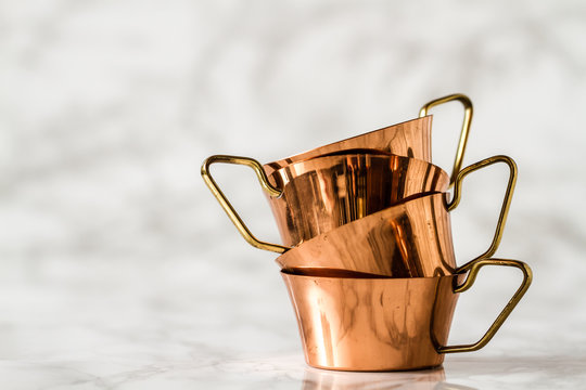 Copper Cups with Handle for Water, Tea, coffee or wine White Woodeen Background
