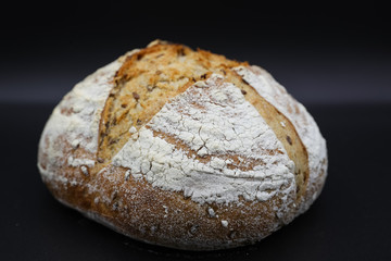 Fresh bread with seasonings on a dark background