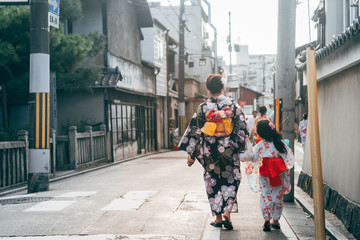 mother and daughter walking at kyoto street with traditional kimono costume