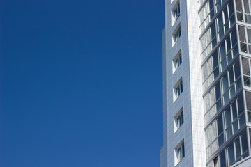 buildings facade on blue sky background with empty space for copy or text