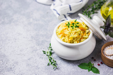 Rice and roasted vegetables in a pot. Selective focus, space for text.