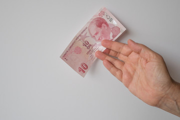 Turkish lira held on a white background