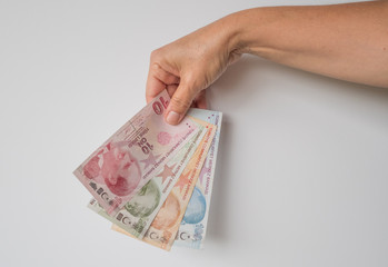 Turkish lira held on a white background