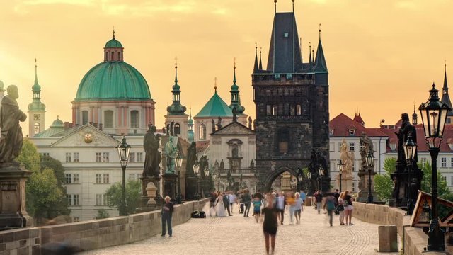 people walking on charles bridge timelapse at sunrise prague