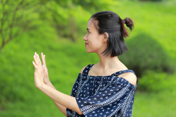 hand sign of woman in green background