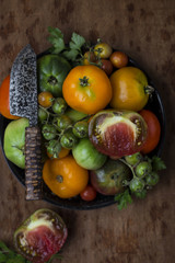 Colorful fresh tomatoes on vintage wooden background