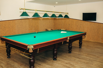Billiard table with cue balls on it. Sports and indoor games free time concept.