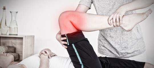 Composite image of masseuse stretching the right leg of an