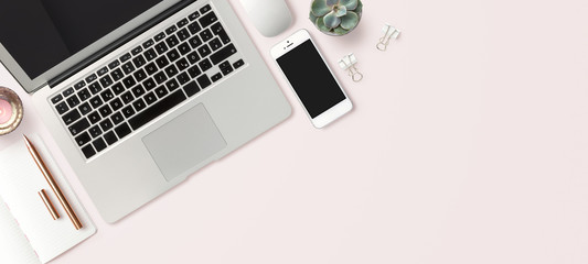 bright feminine banner / header with a stylish workspace with laptop computer, smartphone, modern office accessories and a small succulent on a blush table, top view / flat lay - obrazy, fototapety, plakaty
