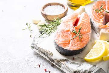 Salmon steak fresh fish with spices close up.