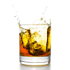 Whisky glass with splashes, isolated on white