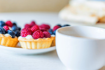 Sweet tarts with mixed berries on a plate