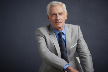 Confident senior business man, studio portrait