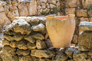 Old pot on an stone wall, archaeological park of Shiloh, Israel