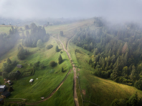 Arial Veiw Of Rural Road, Green Field And Trees. Drone Shot