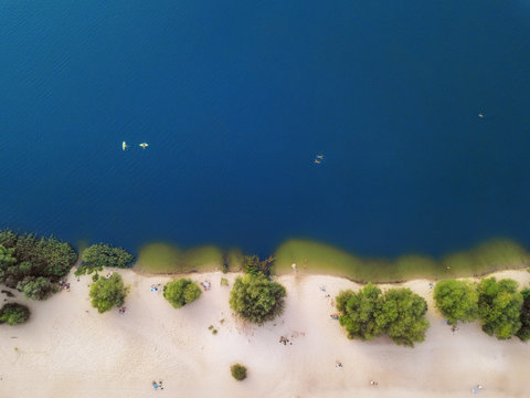 Arial Veiw Of Sandy Beach, Green Trees And Blue Sea (ocean, Lake, River). Drone Shot