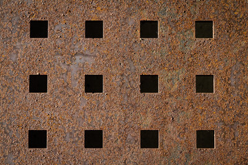Rusty Metal Grill with Square Holes in it