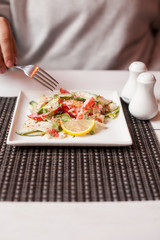 man eating japanese Shrimp Salad with cucumber, lime and caviar