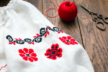 Embroidery in Russian style, national clothes, wooden background