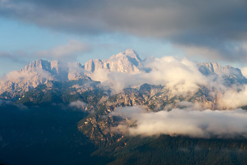 Magical dolomites mountains with snow and white clouds