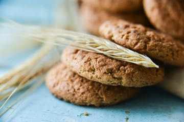 fresh oatmeal cookies in a bag made of paper on wooden background
