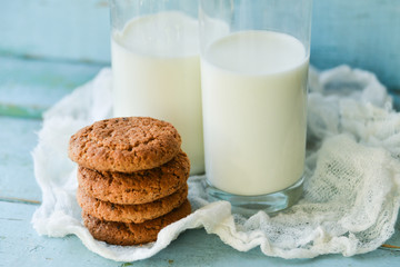 oat cookies and milk on blue wooden background