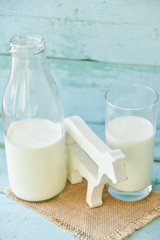 milk bottle, glass of milk, a figure of a cow the concept of rural food, fresh food