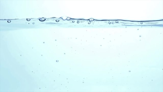Ice cubes falling under water in slow motion
