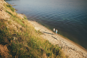 Obraz na płótnie Canvas cute couple is running on the seaside