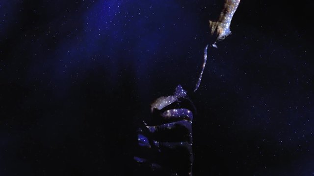 Double exposure: two starfields; a faithful man praying God with a rosary in his old wrinkled hands, showing angst on his face.
