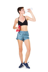 young exercise woman drinking water on isolated white background