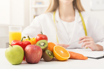 Nutritionist desk with fruit and measuring tape