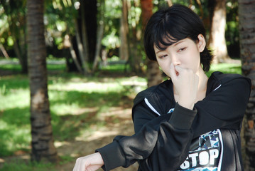 Beautiful girl teen exercise before jogging in the public park.