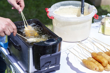 The cook fry the sausage rolls