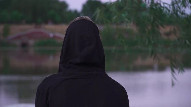 Young guy in black raglan and a dressed hood