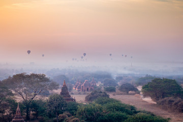 stunning sunrise over the plain of Bagan Myanmar (Burma) with balloons rising in the morning fog