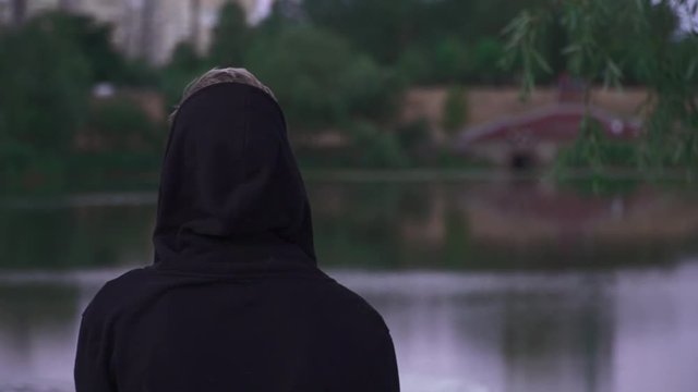Young guy in black raglan and a dressed hood