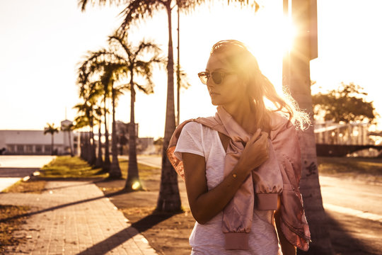 beautiful girl with sunglasses at sunset