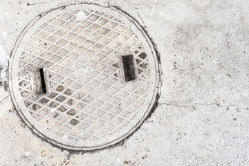 white concrete and manhole cover Drain texture background