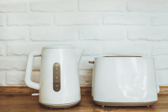 white kettle and toaster mockup stand on a wooden table on a white brick wall background