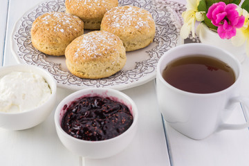 Traditional English cream tea. English scones with clotted cream and raspberry jam.