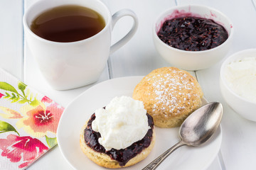 Traditional English cream tea. English scones with clotted cream and raspberry jam.